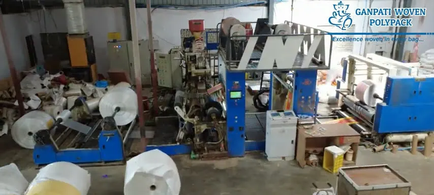 Extrusion lamination line with fabric rolls